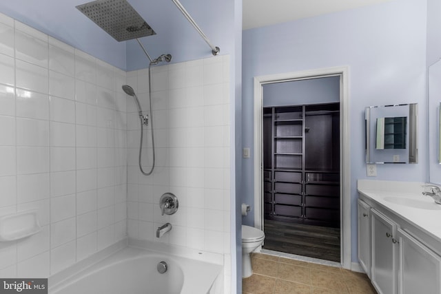 full bath featuring toilet, washtub / shower combination, vanity, and tile patterned floors