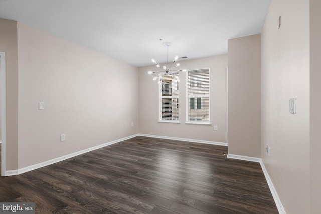 interior space with dark wood-style floors, visible vents, baseboards, and a notable chandelier