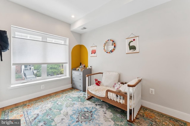 bedroom featuring baseboards, recessed lighting, wood finished floors, and visible vents