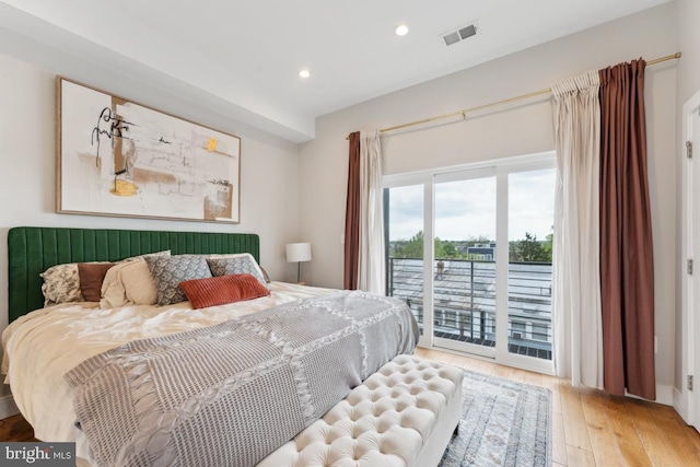 bedroom featuring recessed lighting, visible vents, hardwood / wood-style flooring, and access to exterior