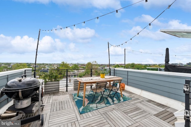 balcony featuring grilling area and outdoor dining space