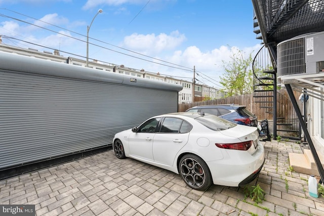 view of parking with fence