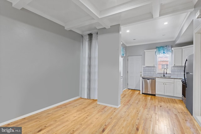 kitchen featuring a sink, backsplash, dishwasher, and beamed ceiling