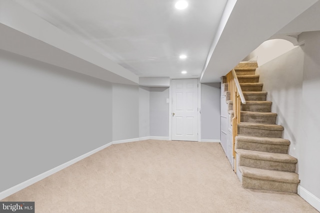 finished basement with stairs, recessed lighting, carpet, and baseboards