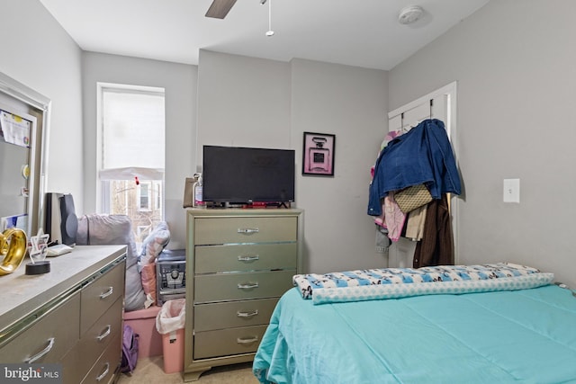 bedroom featuring light carpet and ceiling fan