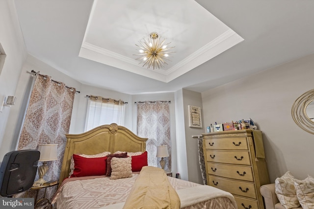 bedroom featuring ornamental molding, a tray ceiling, and an inviting chandelier