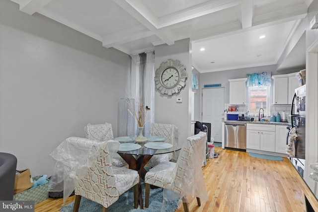 dining space with ornamental molding, beamed ceiling, light wood-type flooring, and coffered ceiling