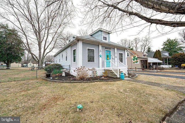 view of front of house with a front yard and fence