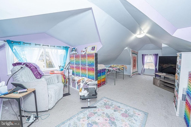 interior space featuring vaulted ceiling and carpet flooring