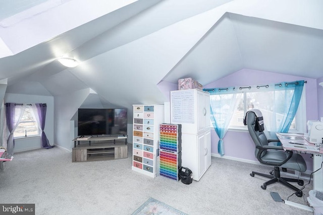 carpeted home office featuring vaulted ceiling and baseboards