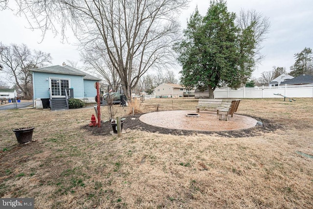 view of yard with a fire pit and fence