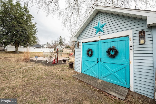 view of outbuilding featuring fence and an outdoor structure