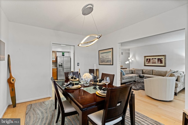 dining room with baseboards and wood finished floors