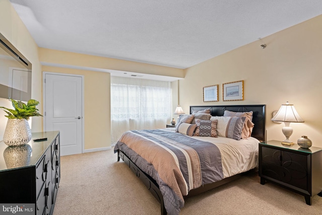 bedroom featuring light colored carpet, visible vents, and baseboards