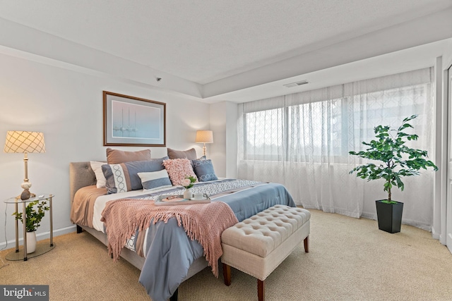 bedroom featuring light colored carpet, visible vents, and baseboards