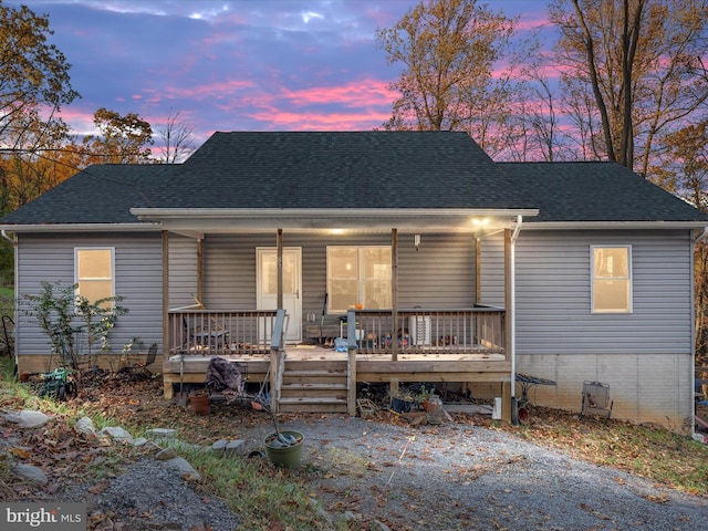 view of front of house featuring a porch and roof with shingles