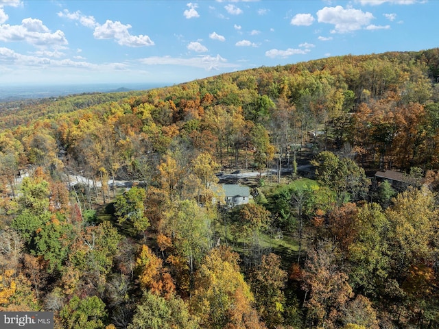 drone / aerial view featuring a view of trees