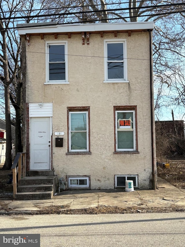 view of front of house with entry steps and stucco siding