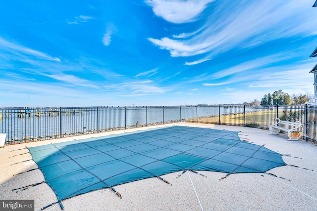 view of pool featuring a water view, fence, and a fenced in pool