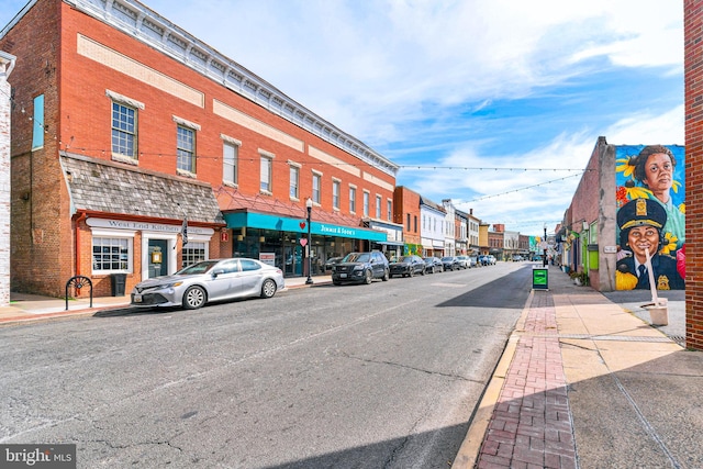 view of street with curbs, sidewalks, and street lights