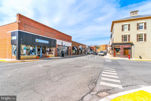 view of road featuring curbs, sidewalks, and street lights