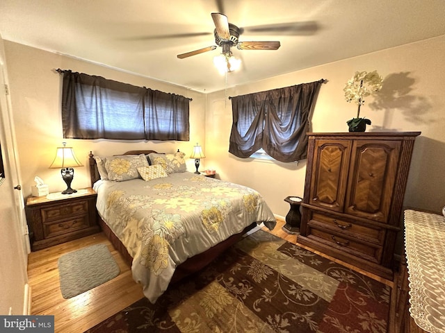 bedroom with a ceiling fan and light wood-type flooring