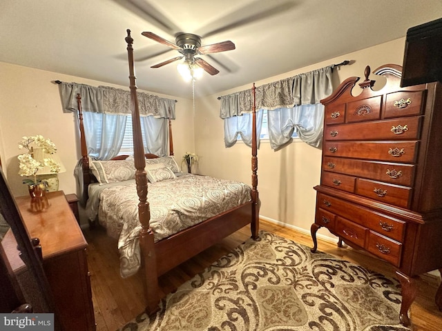 bedroom with light wood-style floors, baseboards, and a ceiling fan