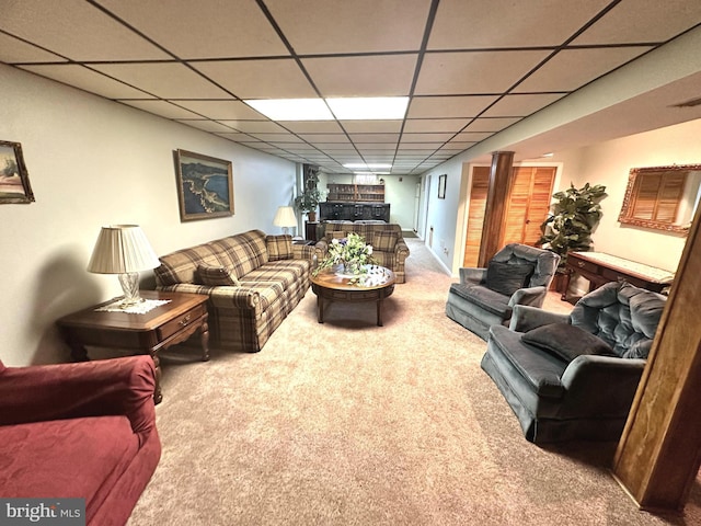 living room featuring visible vents, carpet, and a paneled ceiling