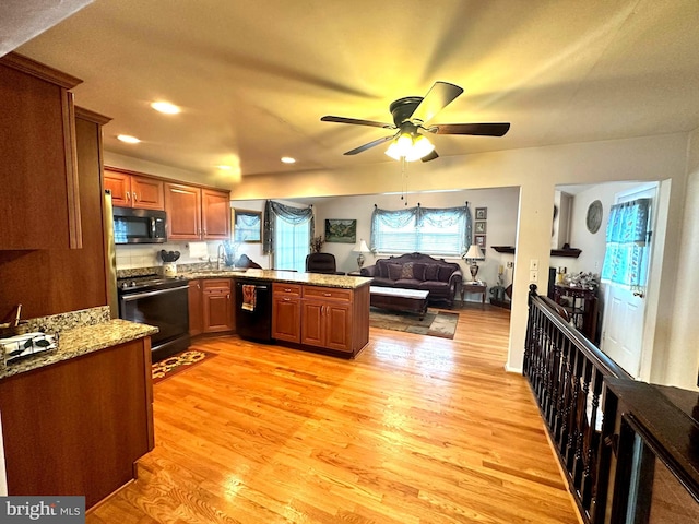 kitchen with brown cabinets, stainless steel electric stove, open floor plan, dishwasher, and a peninsula