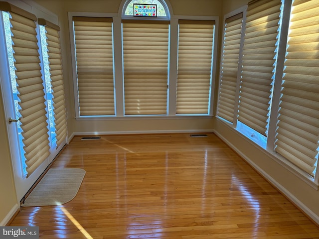 unfurnished sunroom featuring visible vents