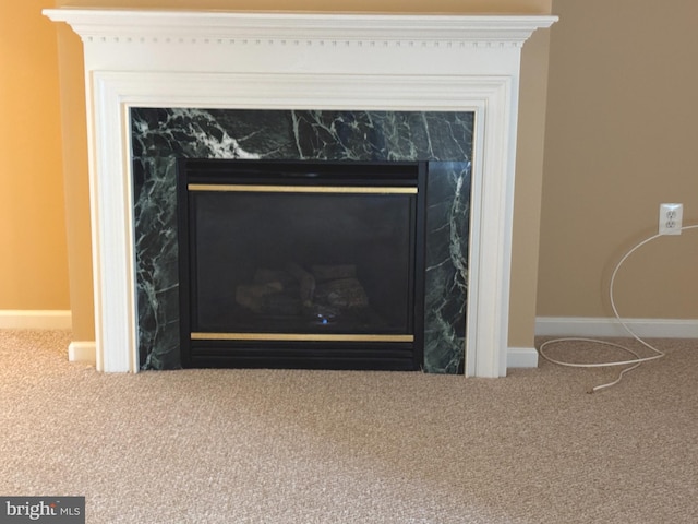 interior details with a high end fireplace, baseboards, and carpet floors