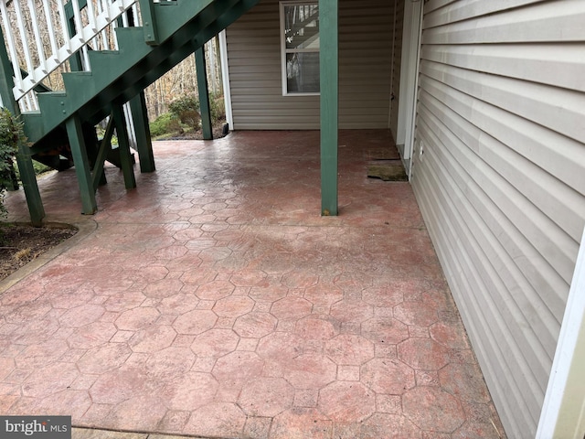 view of patio / terrace with stairs and a carport