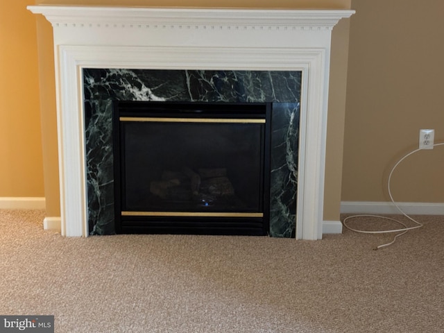 interior details with a fireplace, baseboards, and carpet floors