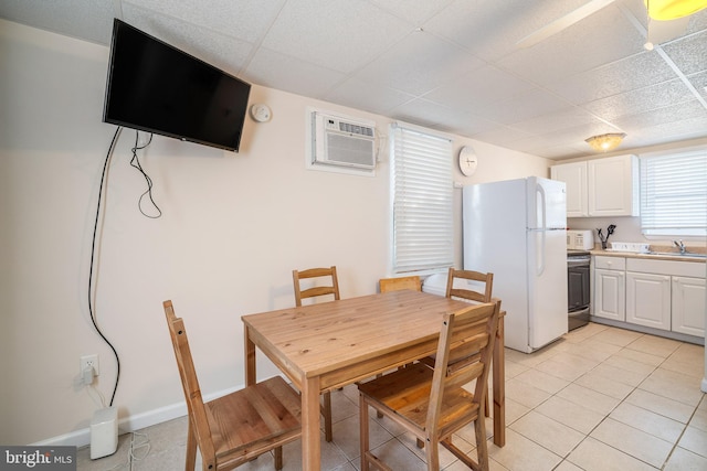 dining room with light tile patterned floors, baseboards, and a wall mounted AC