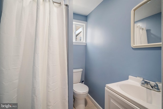 full bathroom with vanity, tile patterned flooring, toilet, and baseboards