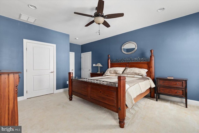 bedroom featuring light carpet, a ceiling fan, visible vents, and baseboards