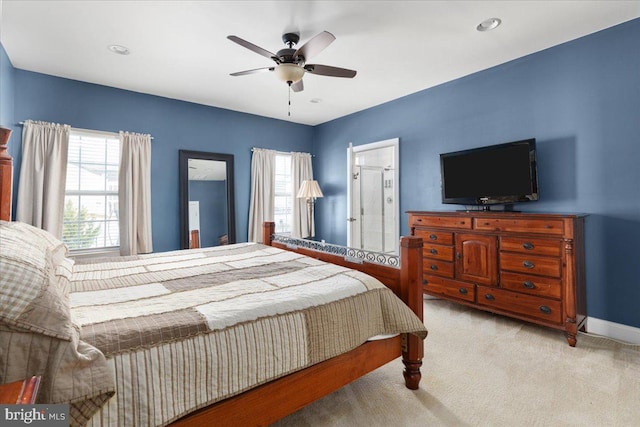 bedroom featuring ceiling fan, baseboards, and light colored carpet