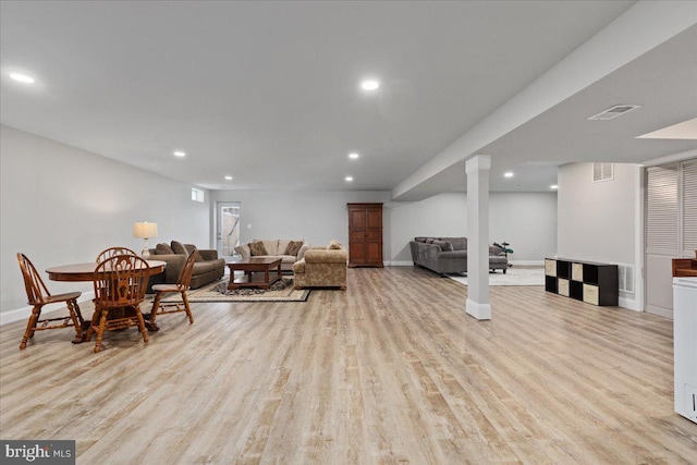 living area with recessed lighting, baseboards, visible vents, and light wood finished floors