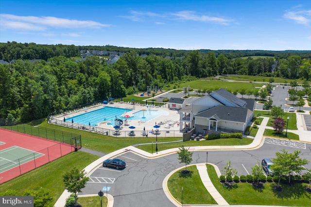 birds eye view of property featuring a view of trees