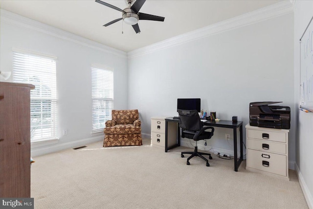 office area featuring light colored carpet, a ceiling fan, baseboards, visible vents, and crown molding