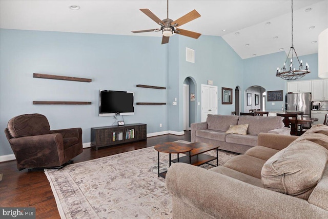 living area featuring dark wood-style floors, arched walkways, a ceiling fan, high vaulted ceiling, and baseboards