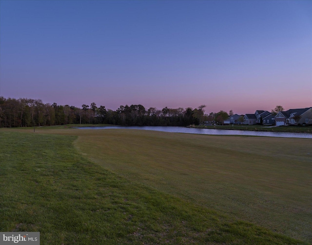 view of community featuring a water view and a lawn