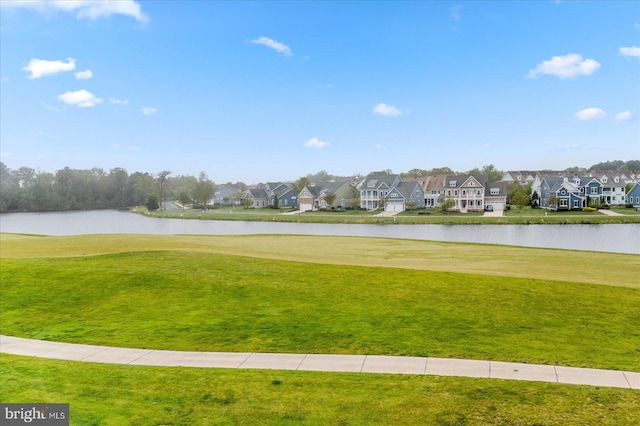 view of home's community featuring a residential view, a water view, and a lawn