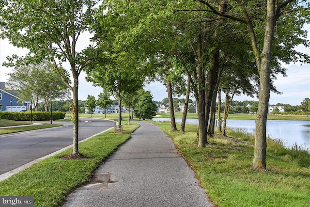 view of road with a water view and sidewalks