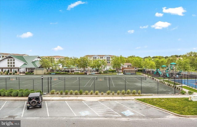 uncovered parking lot with fence and playground community