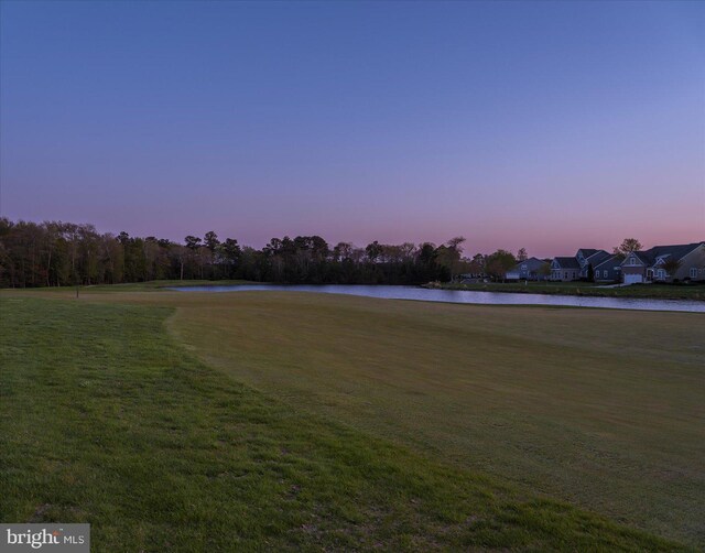 surrounding community with a yard and a water view