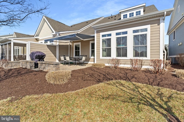 rear view of property featuring a patio area and a sunroom