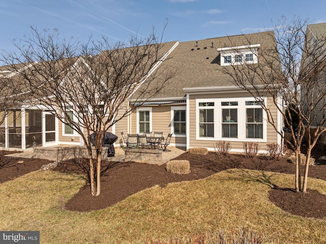 back of property featuring a patio area and a shingled roof