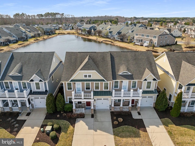 birds eye view of property featuring a water view and a residential view