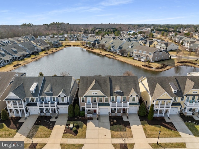 birds eye view of property featuring a water view and a residential view